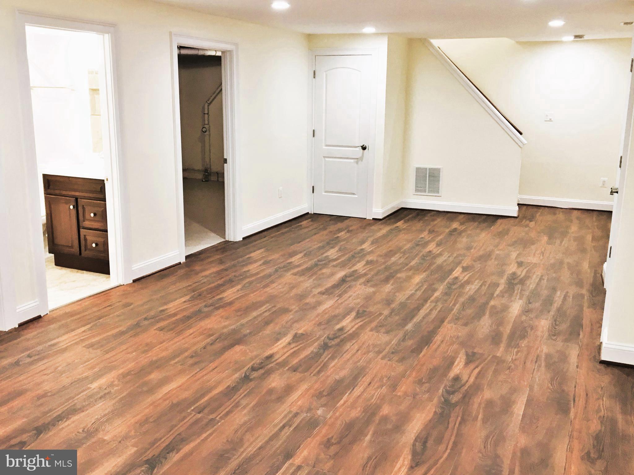 11514 Seven Locks Road Potomac, MD 20854 - Photo 53 of 72 an empty room with wooden floor and windows