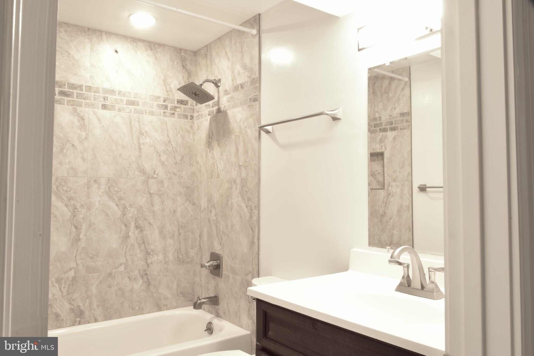 11514 Seven Locks Road Potomac, MD 20854 - Photo 56 of 72 a bathroom with a sink a toilet and shower