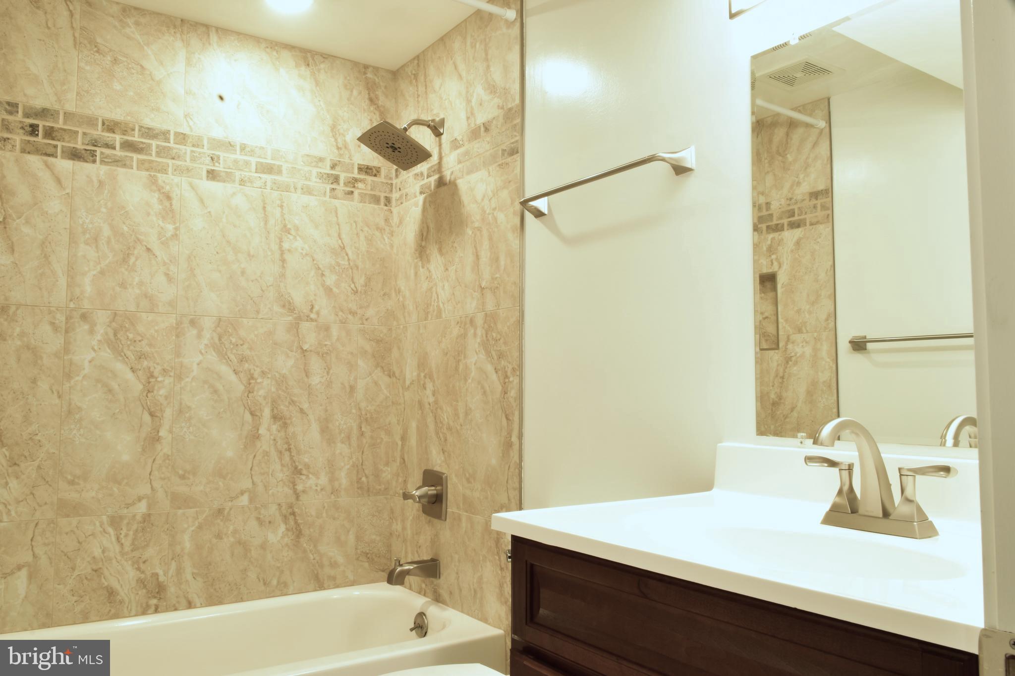 11514 Seven Locks Road Potomac, MD 20854 - Photo 58 of 72 a bathroom with a sink a toilet and shower