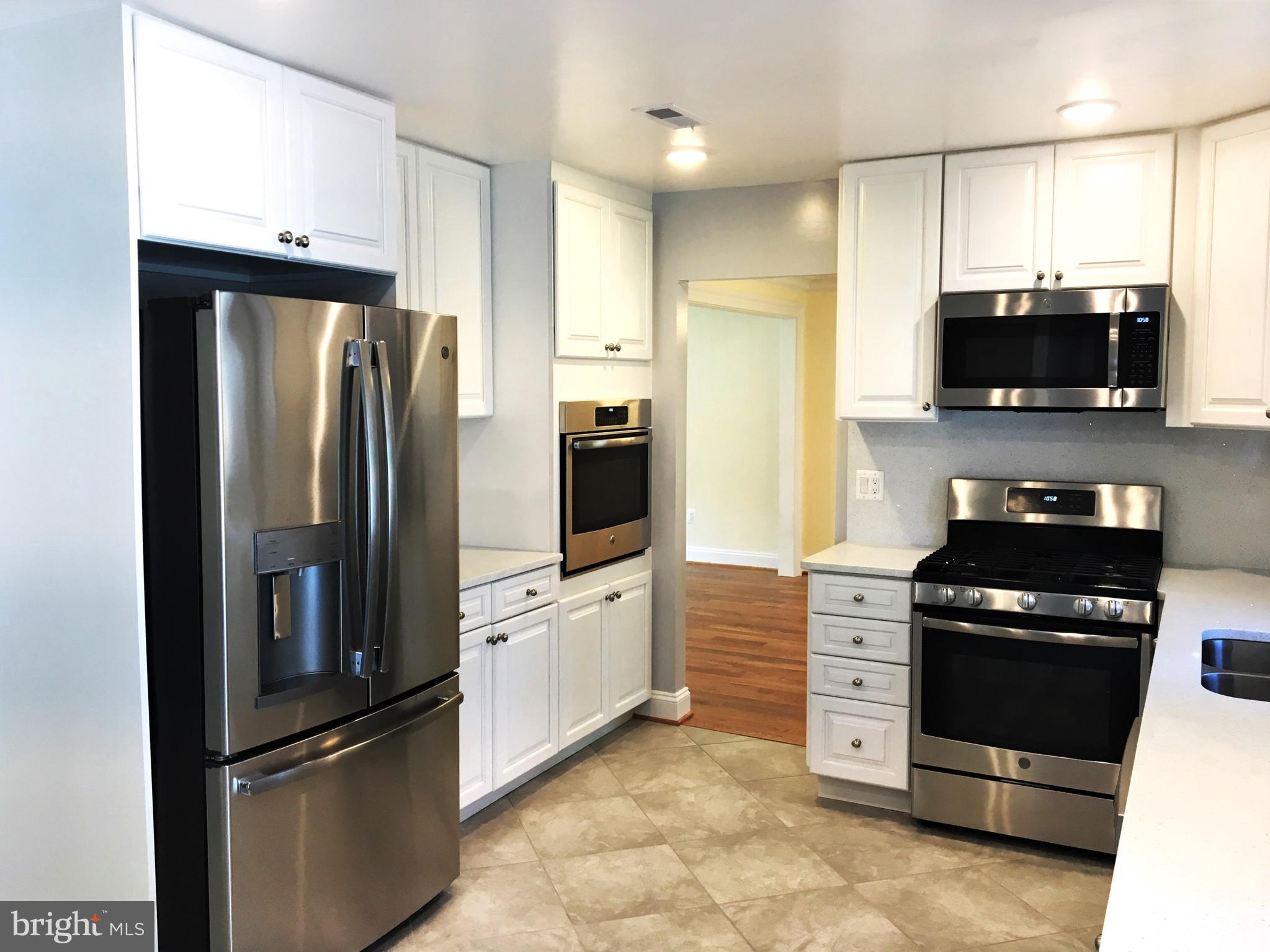 11514 Seven Locks Road Potomac, MD 20854 - Photo 6 of 72 a kitchen with stainless steel appliances and refrigerator