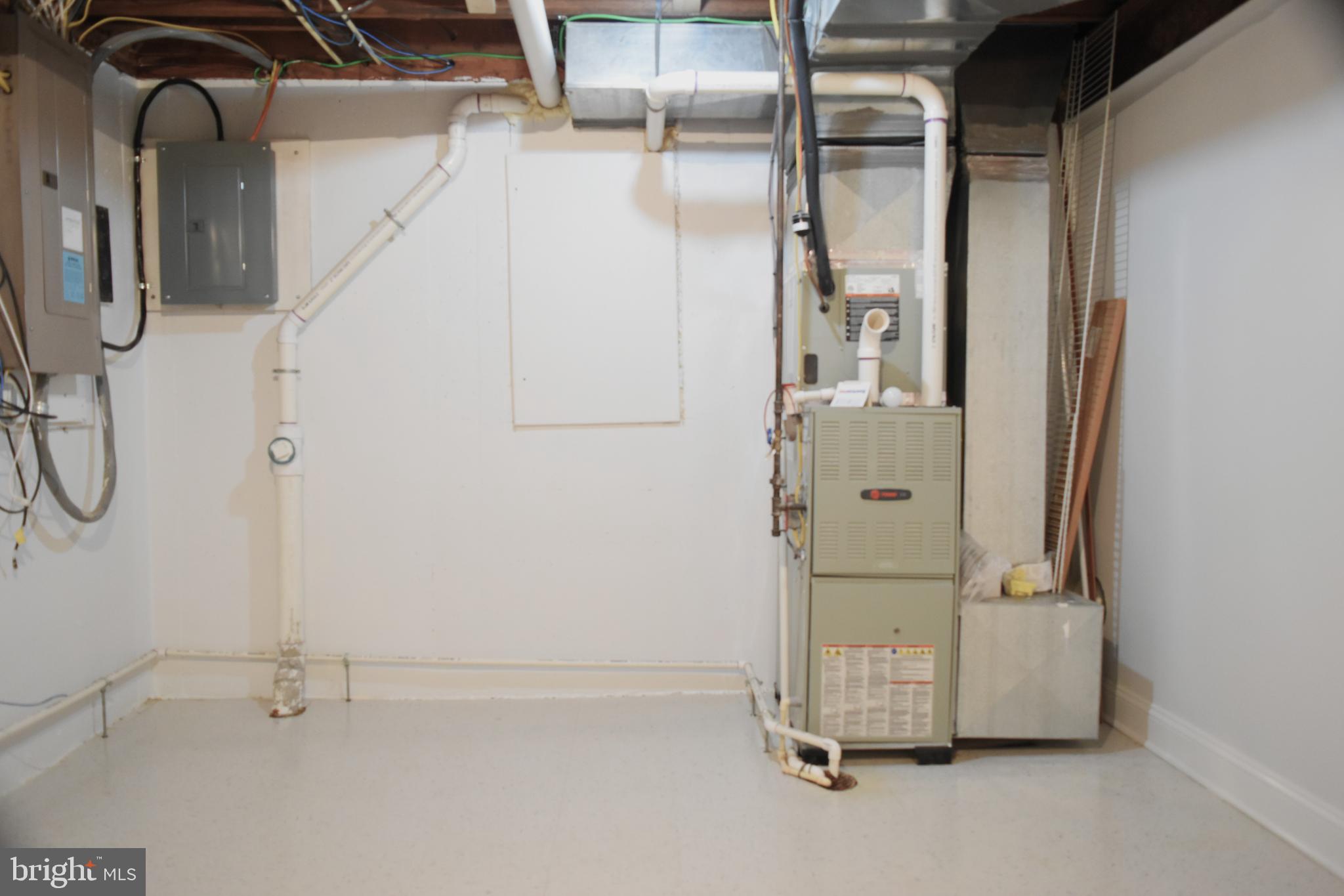 11514 Seven Locks Road Potomac, MD 20854 - Photo 61 of 72 a room with water heater and white walls