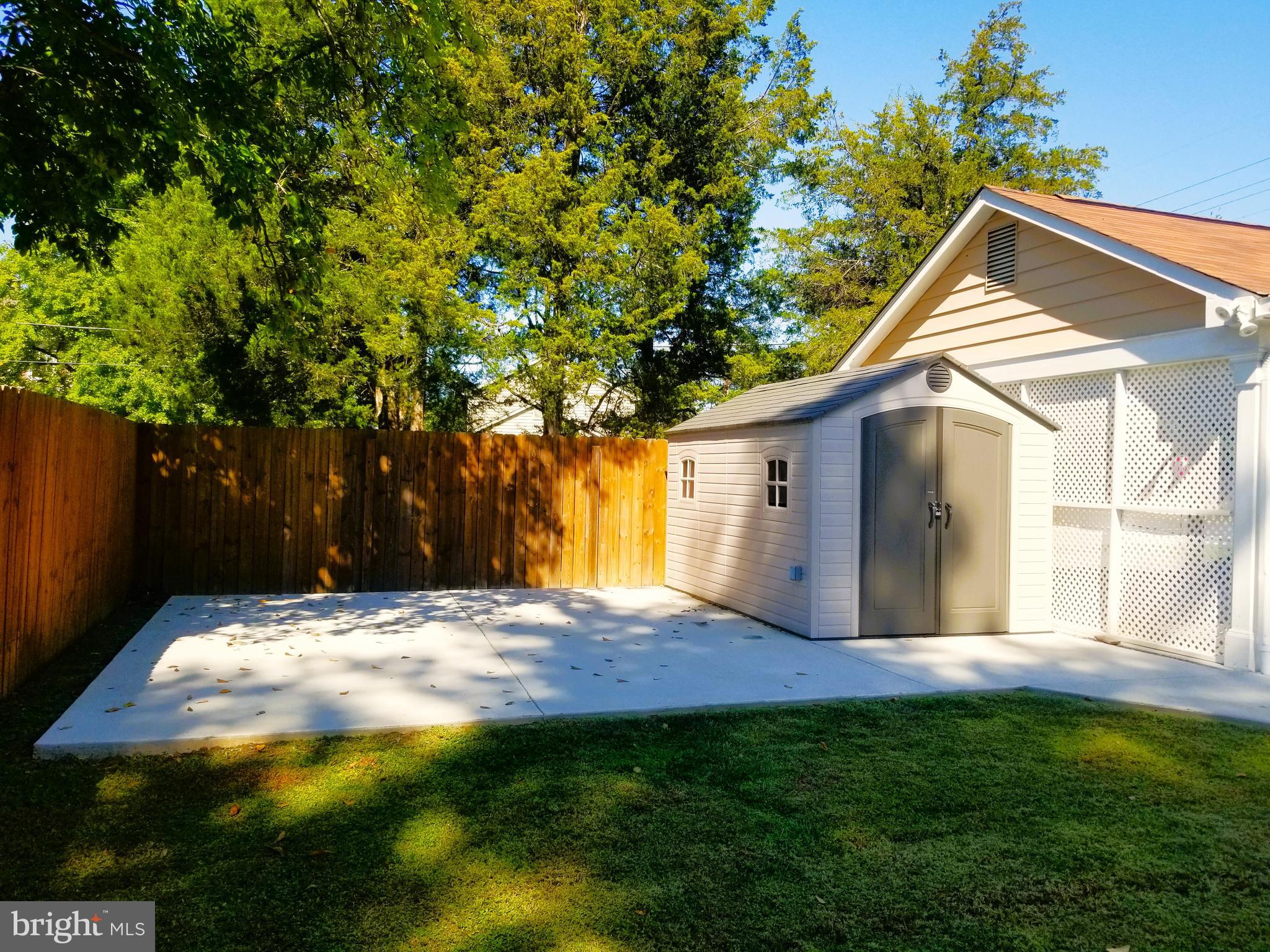 11514 Seven Locks Road Potomac, MD 20854 - Photo 66 of 72 a backyard of a house with large trees and plants