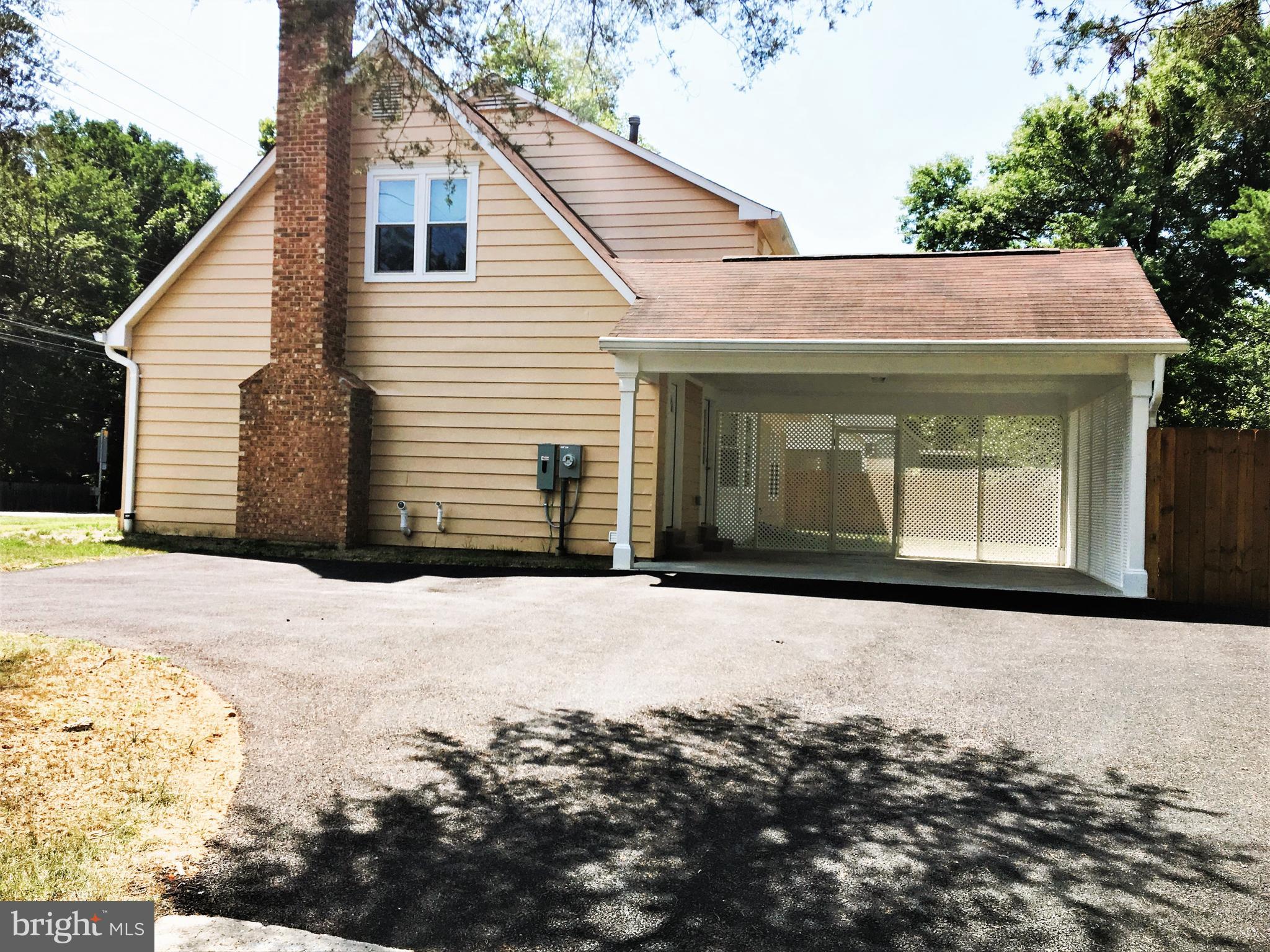 11514 Seven Locks Road Potomac, MD 20854 - Photo 69 of 72 a front view of a house with a snow in the yard