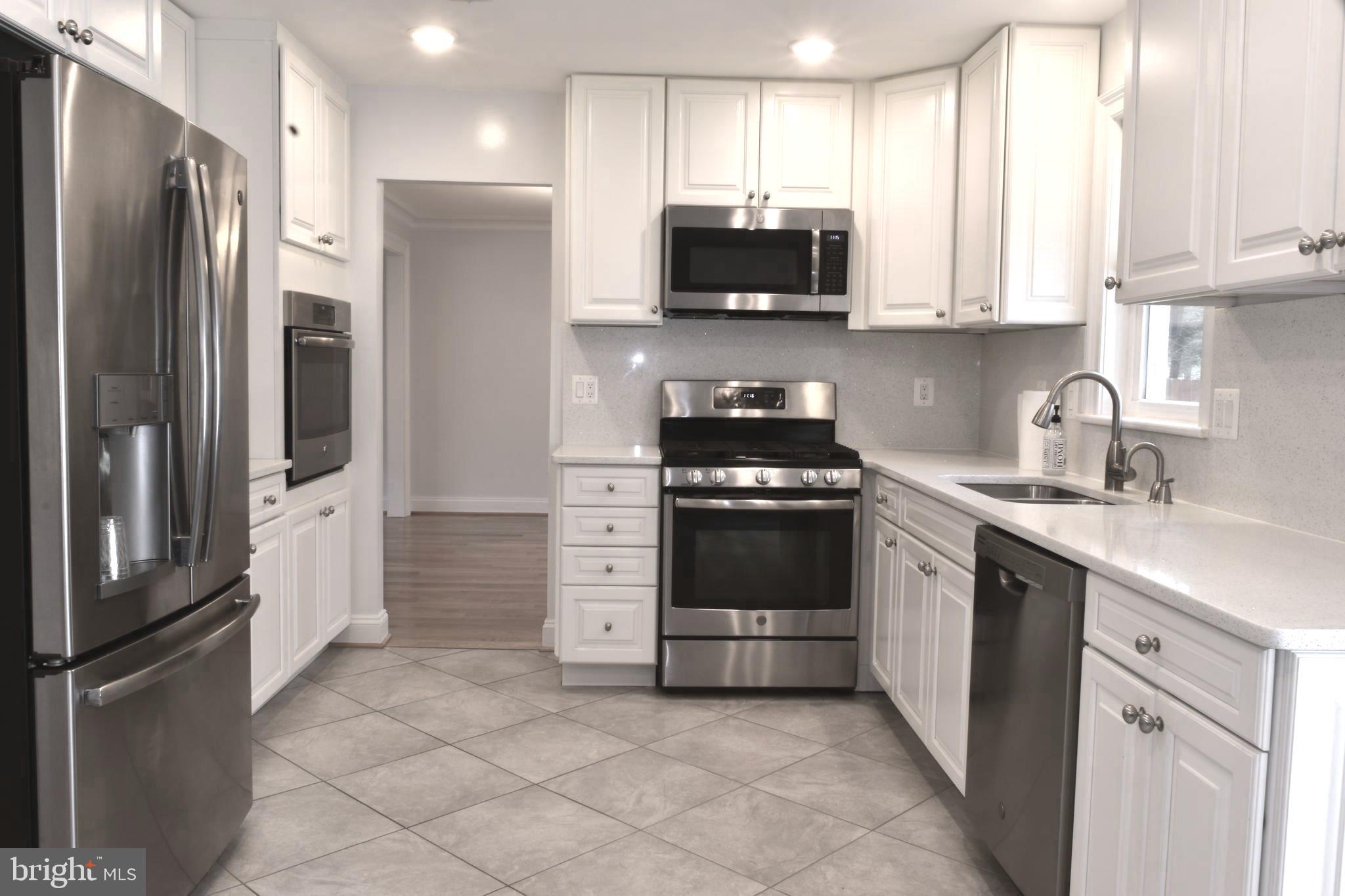 11514 Seven Locks Road Potomac, MD 20854 - Photo 7 of 72 a kitchen with stainless steel appliances a refrigerator stove and sink