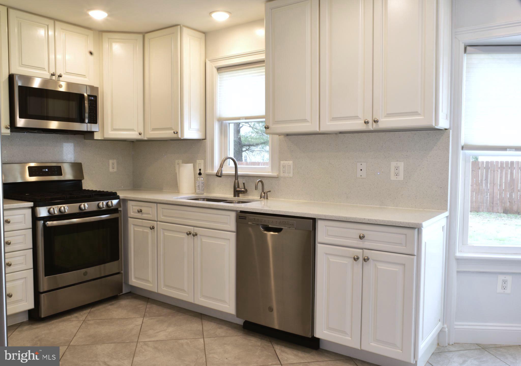 11514 Seven Locks Road Potomac, MD 20854 - Photo 8 of 72 a kitchen with stainless steel appliances granite countertop white cabinets a sink and dishwasher