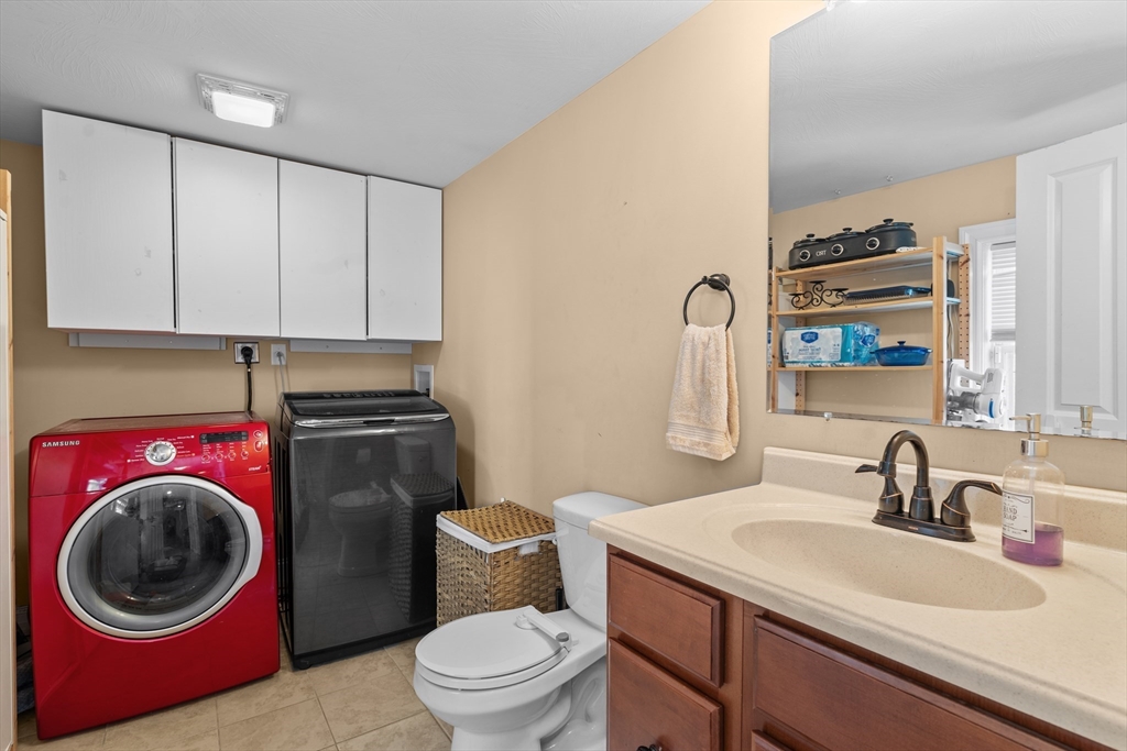 146 South Pleasant Street, Unit 146 Haverhill, MA 01835 - Photo 15 of 28 a bathroom with a toilet a sink and a mirror