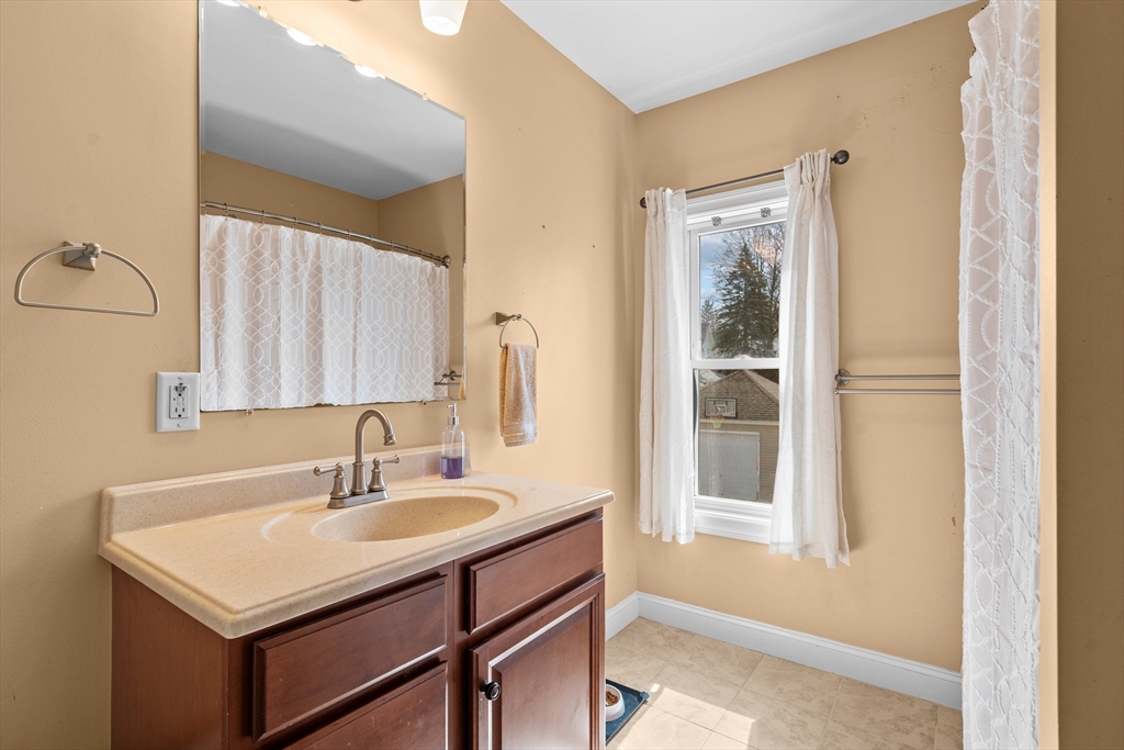 146 South Pleasant Street, Unit 146 Haverhill, MA 01835 - Photo 16 of 28 a bathroom with a sink and a mirror