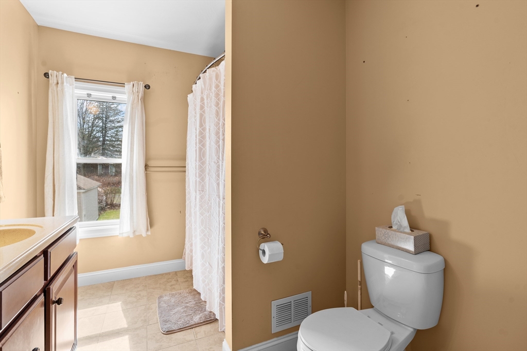 146 South Pleasant Street, Unit 146 Haverhill, MA 01835 - Photo 17 of 28 a white toilet sitting next to a window