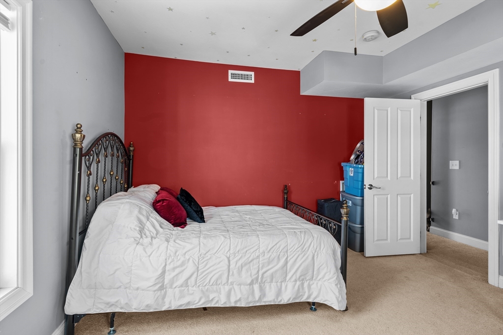 146 South Pleasant Street, Unit 146 Haverhill, MA 01835 - Photo 20 of 28 a bedroom with a bed and cabinets
