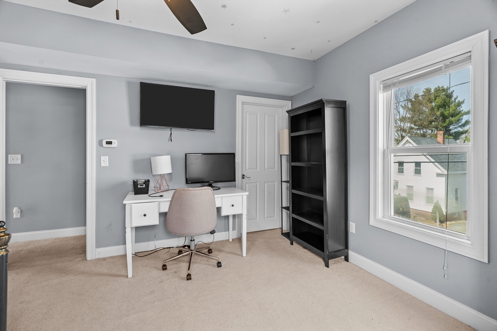 146 South Pleasant Street, Unit 146 Haverhill, MA 01835 - Photo 21 of 28 a work room with furniture a flat screen tv and a window