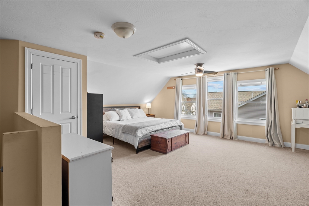 146 South Pleasant Street, Unit 146 Haverhill, MA 01835 - Photo 22 of 28 a spacious bedroom with a bed a couch and a large window