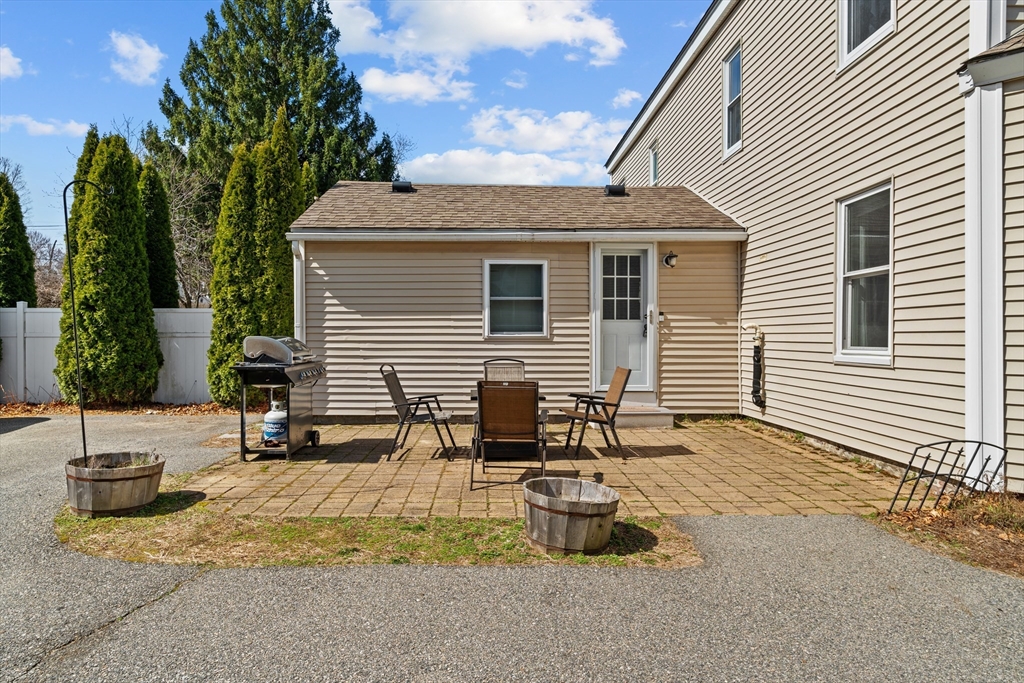 146 South Pleasant Street, Unit 146 Haverhill, MA 01835 - Photo 25 of 28 a backyard of a house with table and chairs