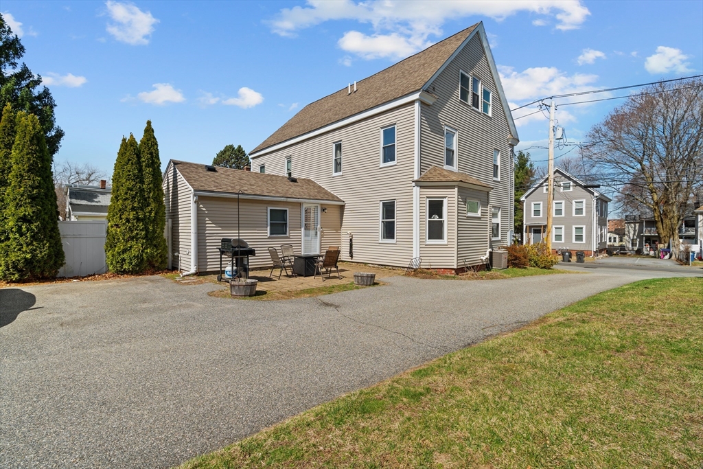 146 South Pleasant Street, Unit 146 Haverhill, MA 01835 - Photo 26 of 28 a view of a house with table and chairs in patio