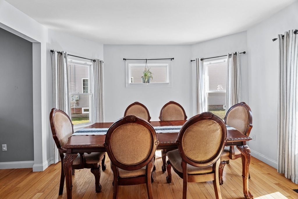 146 South Pleasant Street, Unit 146 Haverhill, MA 01835 - Photo 8 of 28 a view of a dining room with furniture window and wooden floor
