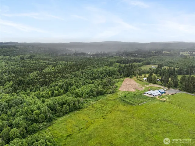 an aerial view of a houses with a yard
