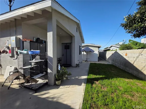 a view of a backyard with a patio and a fireplace