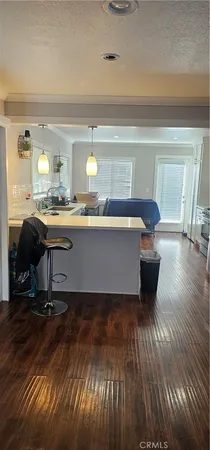 a view of a living room and kitchen with a large window