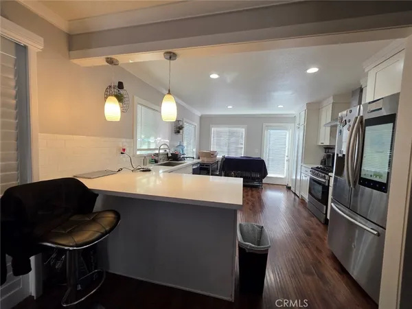 a kitchen with a sink stainless steel appliances and cabinets