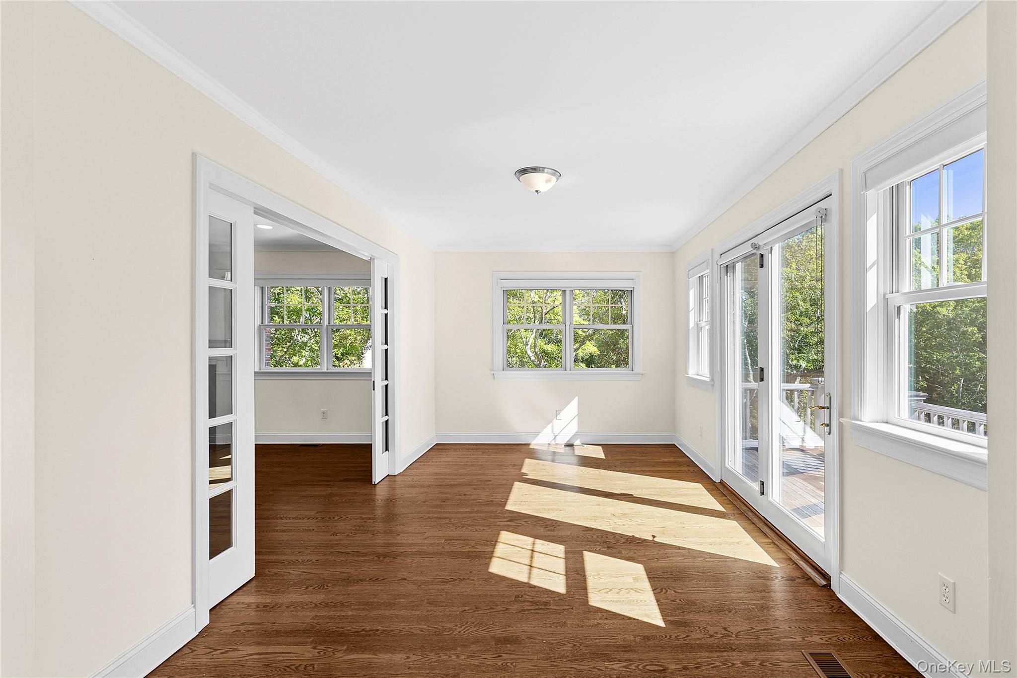 22 Old Trail Road Water Mill, NY 11976 - Photo 11 of 38 a view of an empty room with wooden floor and a window