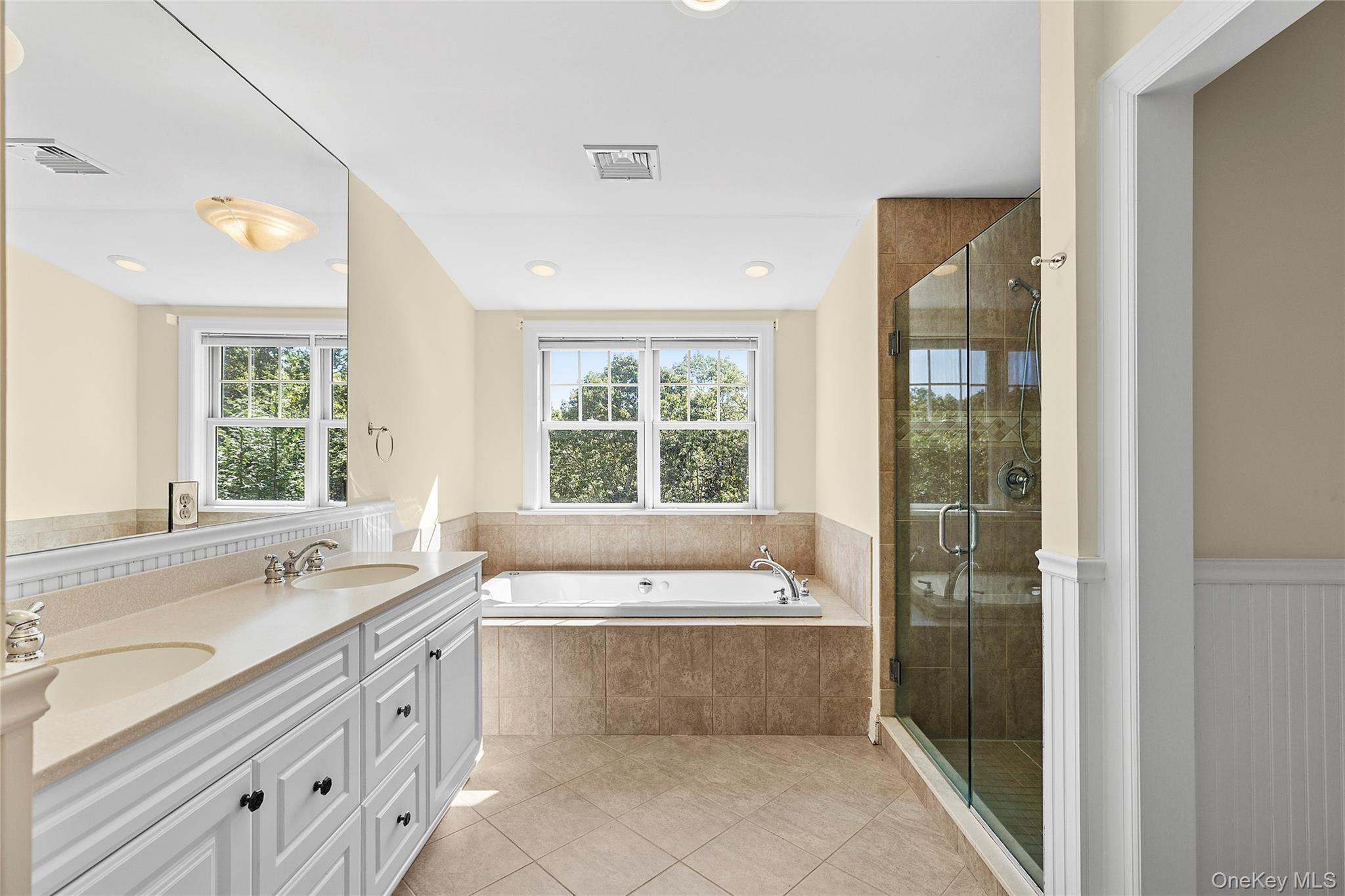 22 Old Trail Road Water Mill, NY 11976 - Photo 19 of 38 a spacious bathroom with a tub a sink and a large window