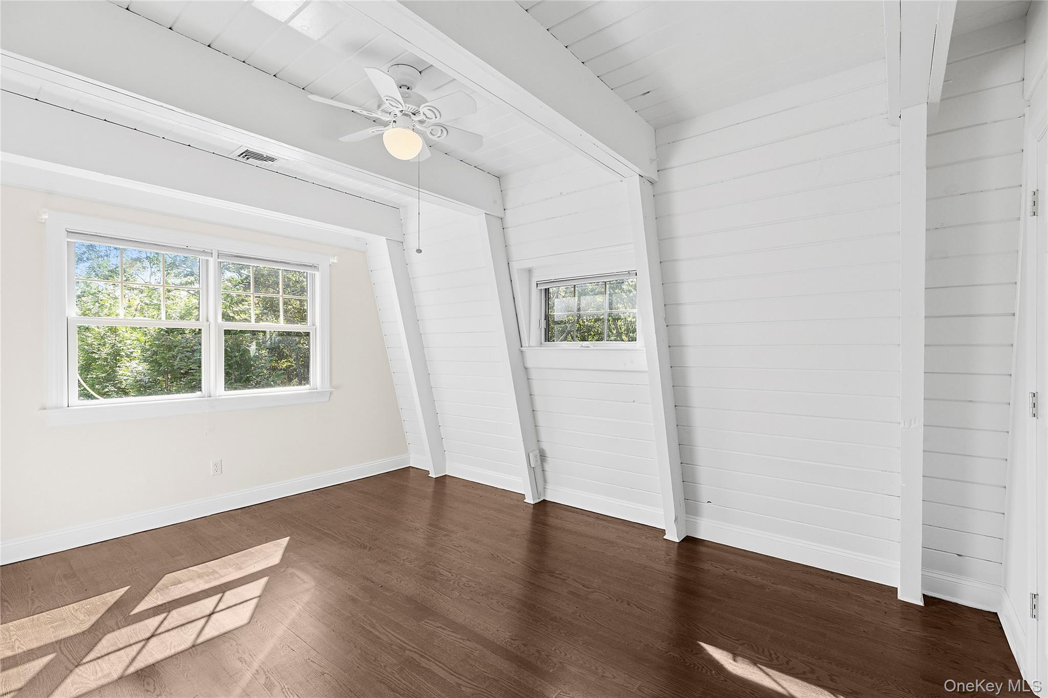 22 Old Trail Road Water Mill, NY 11976 - Photo 21 of 38 an empty room with wooden floor and windows