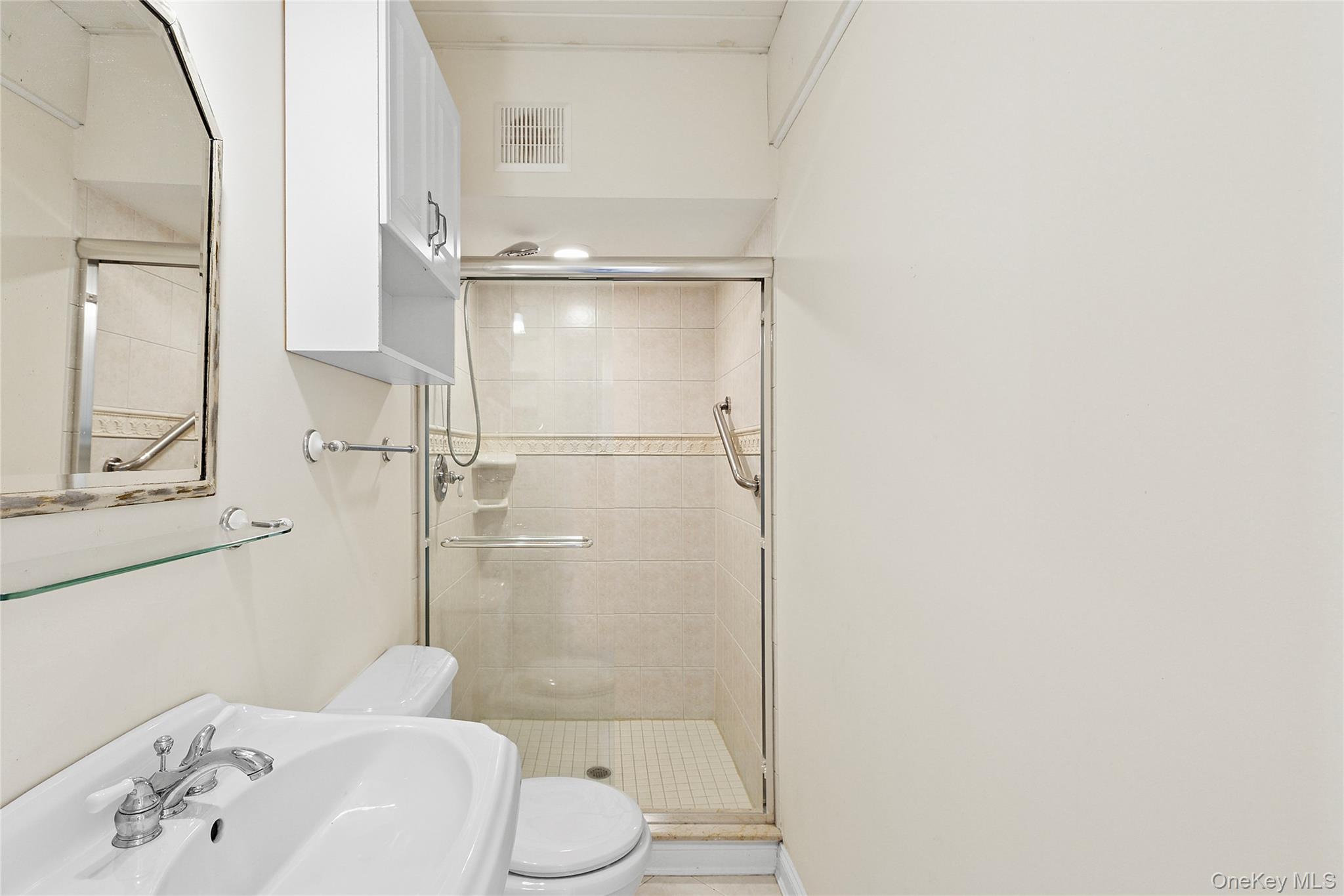 22 Old Trail Road Water Mill, NY 11976 - Photo 22 of 38 a bathroom with a sink toilet and shower