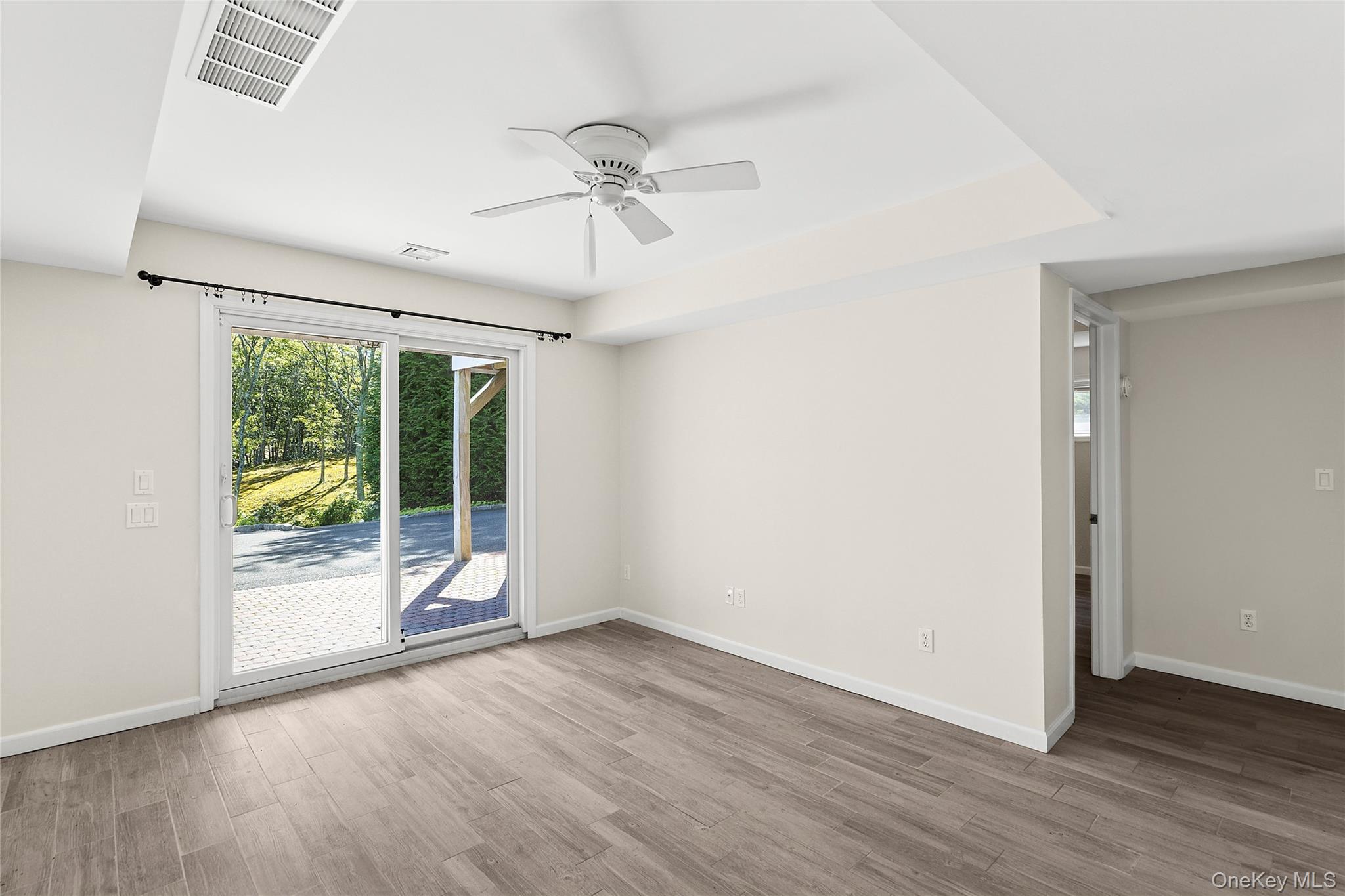 22 Old Trail Road Water Mill, NY 11976 - Photo 25 of 38 an empty room with wooden floor fan and windows