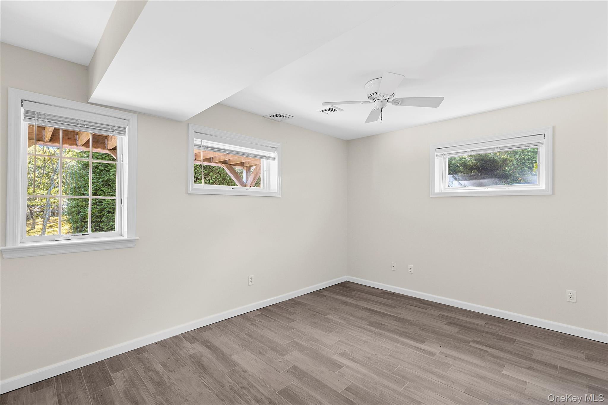 22 Old Trail Road Water Mill, NY 11976 - Photo 26 of 38 a view of an empty room with wooden floor and a window