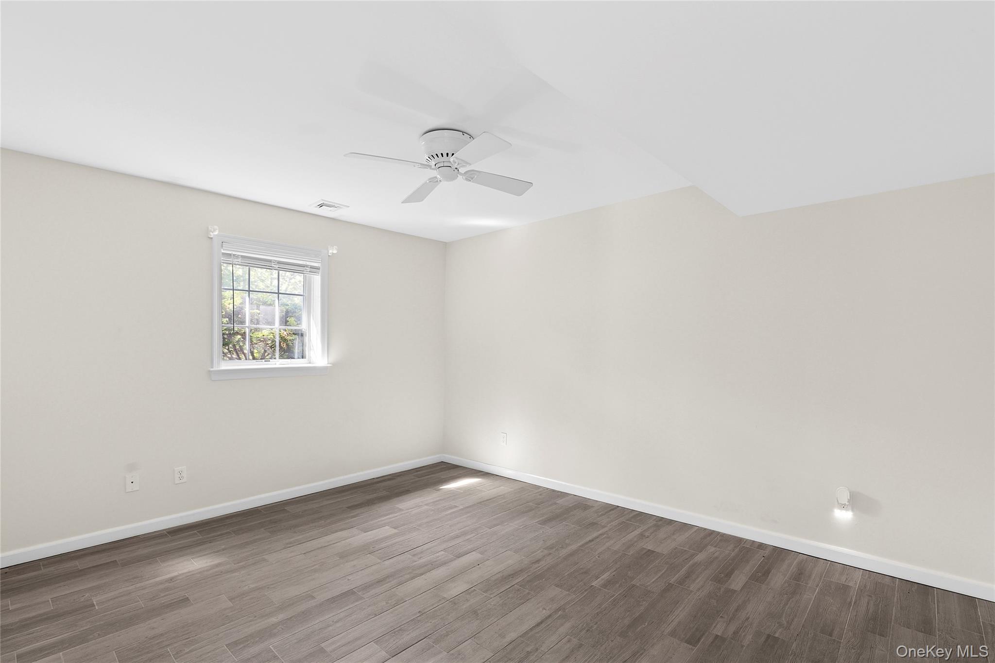 22 Old Trail Road Water Mill, NY 11976 - Photo 28 of 38 wooden floor in an empty room with a window