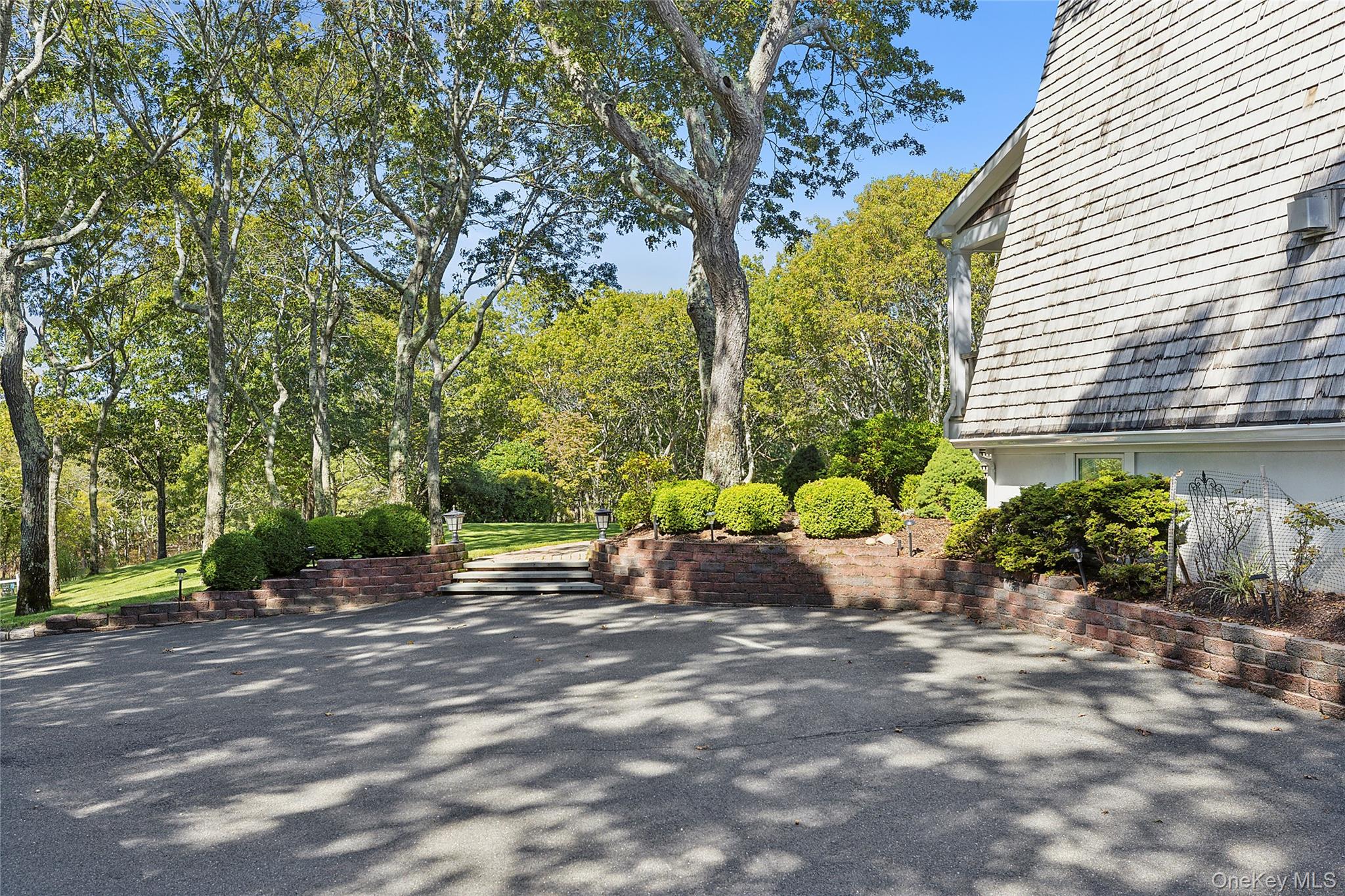 22 Old Trail Road Water Mill, NY 11976 - Photo 5 of 38 a wooden bench sitting in front of a house
