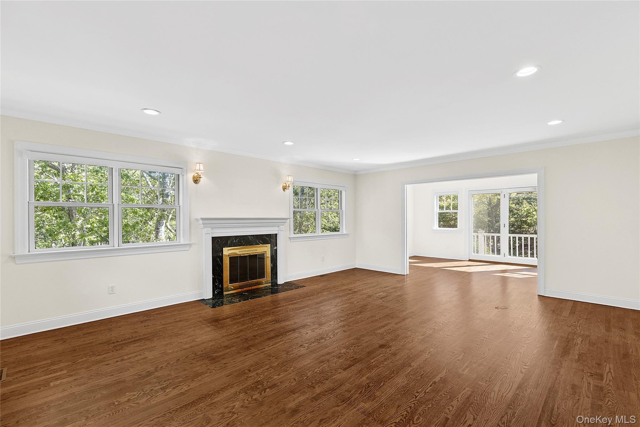 22 Old Trail Road Water Mill, NY 11976 - Photo 7 of 38 an empty room with wooden floor fireplace and windows
