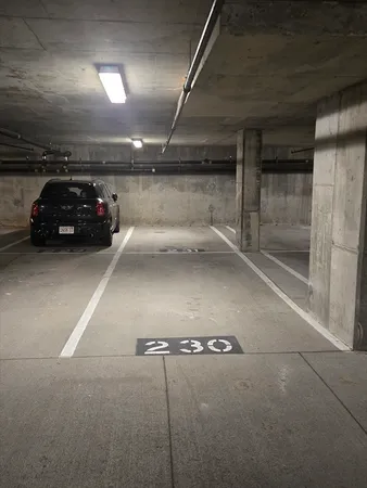 a view of parking garage with cars