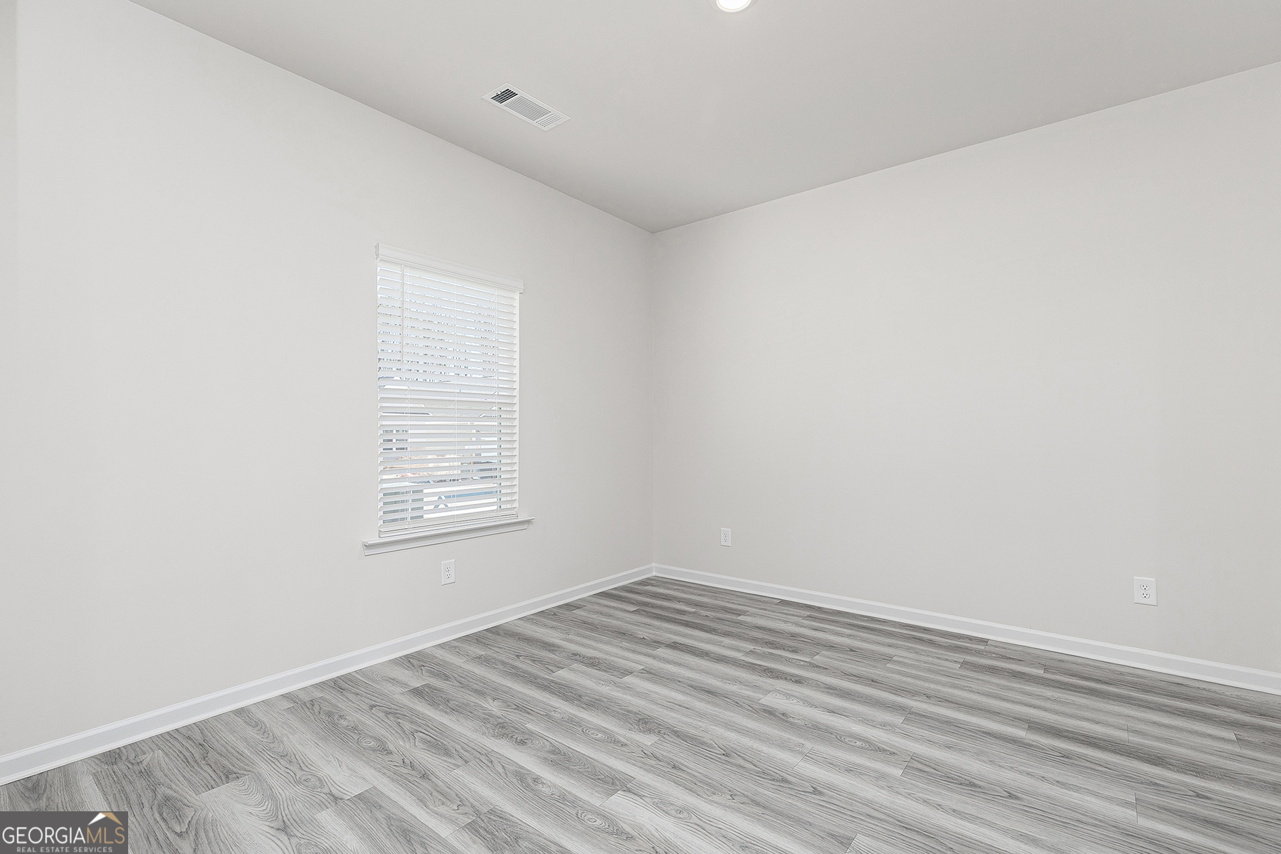 661 Mackenzie Cove Villa Rica, GA 30180 - Photo 11 of 18 an empty room with wooden floor and windows