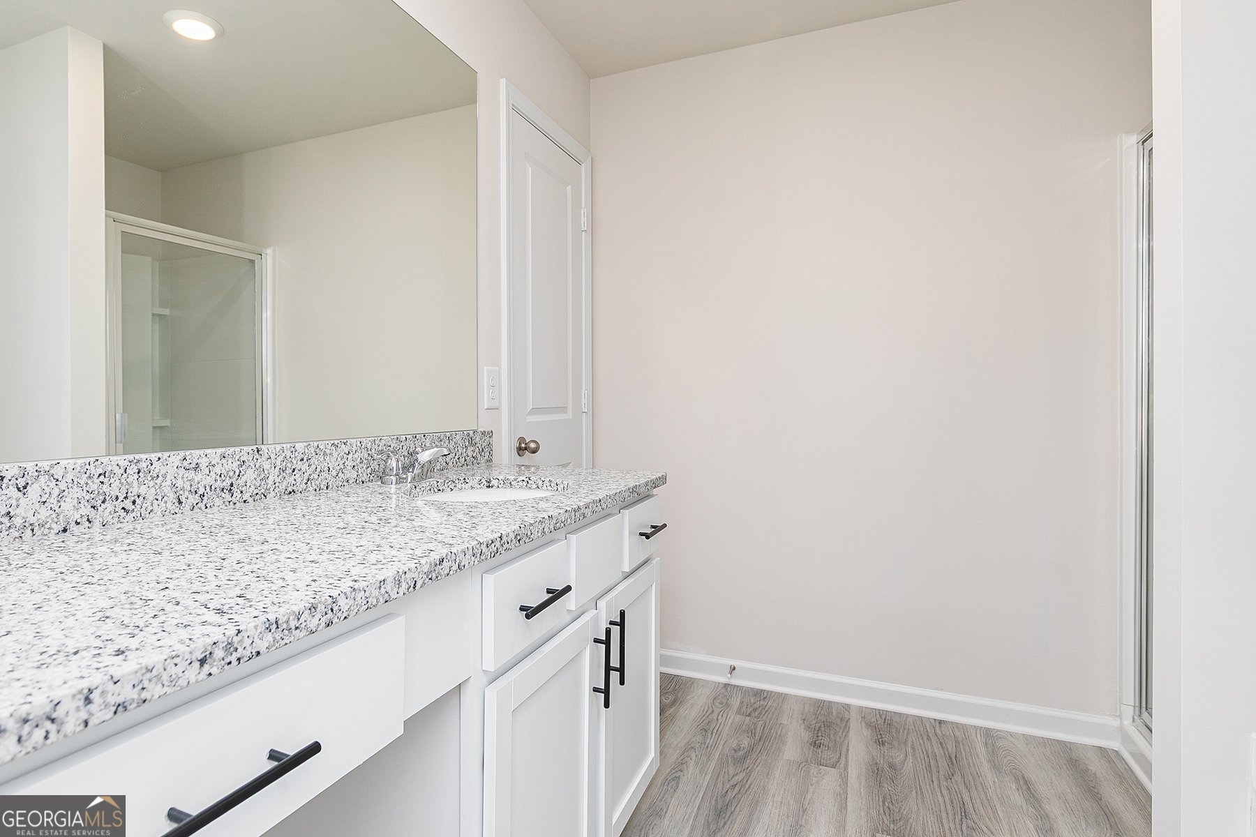 661 Mackenzie Cove Villa Rica, GA 30180 - Photo 14 of 18 a bathroom with a granite countertop sink and a mirror