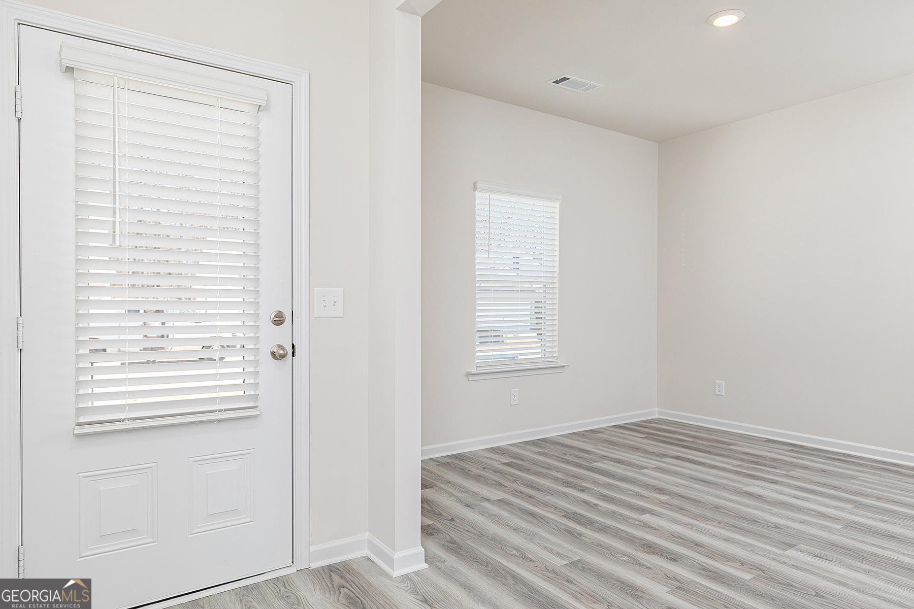661 Mackenzie Cove Villa Rica, GA 30180 - Photo 4 of 18 a view of a room with wooden floor and cabinet