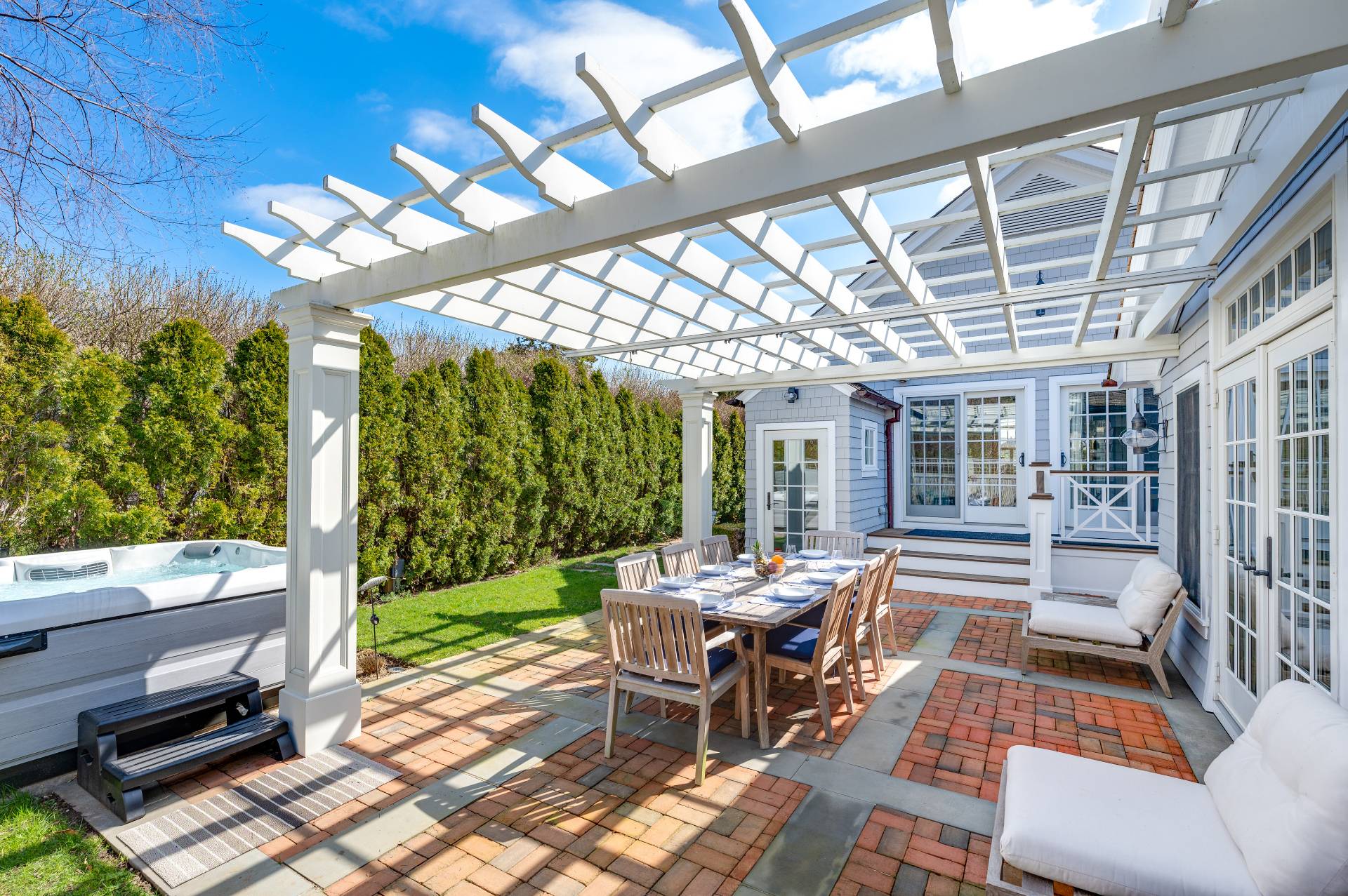 5 Ridge Drive Sag Harbor, NY 11963 - Photo 20 of 27 a view of a patio with a dining table and chairs with wooden floor