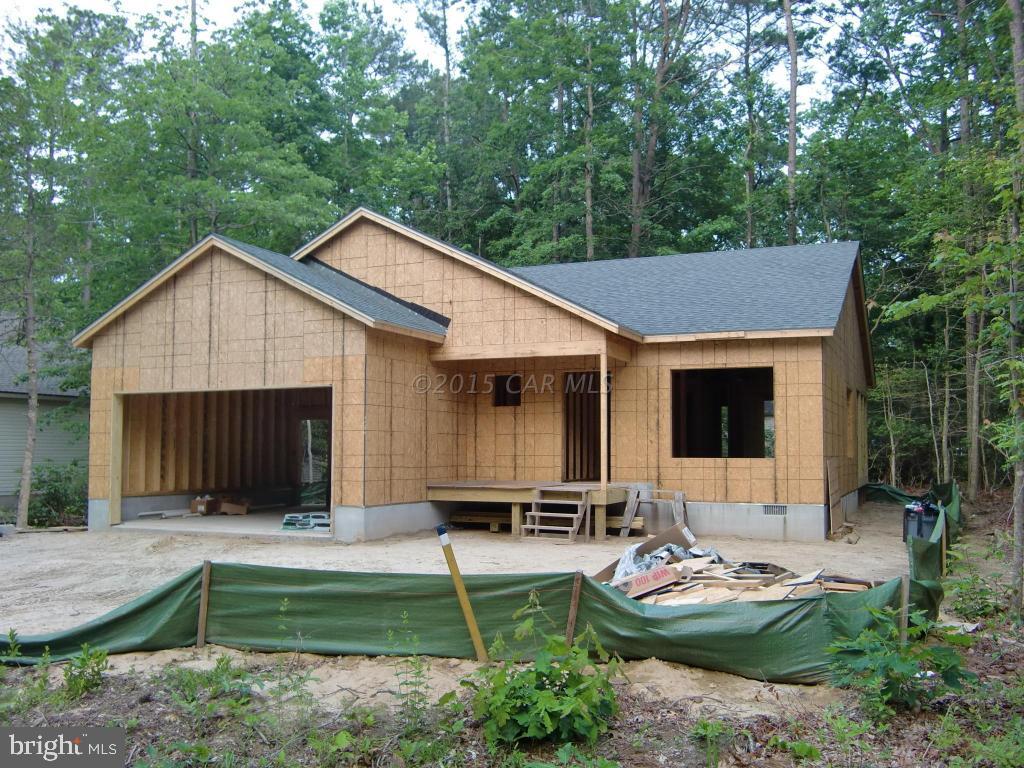 27 Canal Road Ocean Pines, MD 21811 - Photo 1 of 23 a house view with a garden space and garden