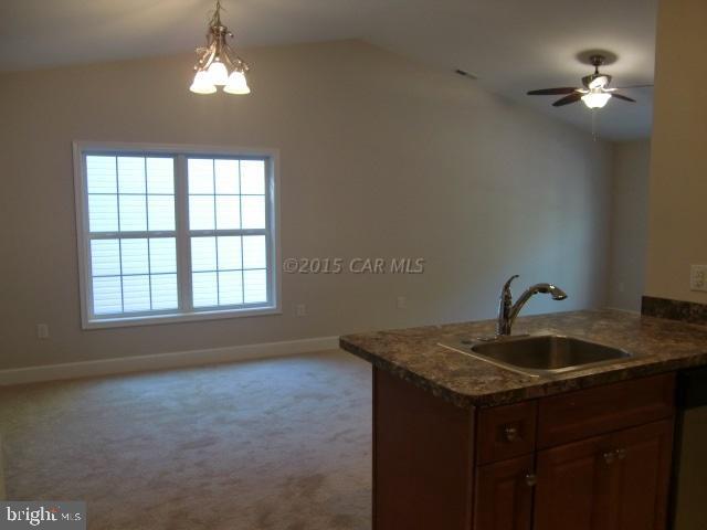 27 Canal Road Ocean Pines, MD 21811 - Photo 11 of 23 a kitchen with a sink and chandelier