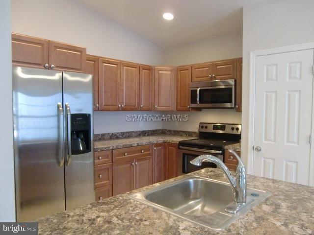 27 Canal Road Ocean Pines, MD 21811 - Photo 12 of 23 a kitchen with stainless steel appliances granite countertop a sink stove and refrigerator