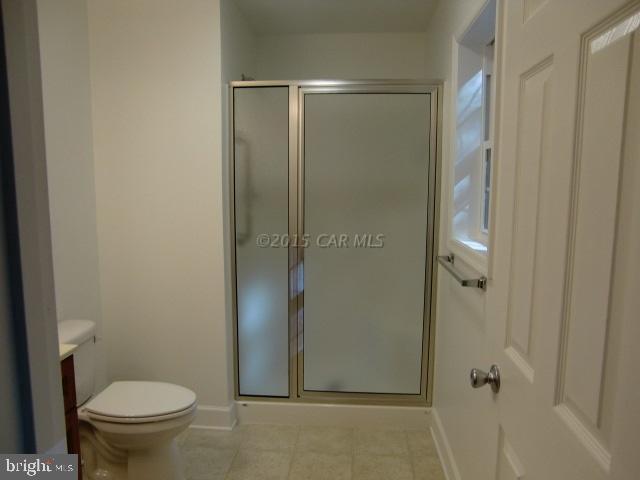 27 Canal Road Ocean Pines, MD 21811 - Photo 17 of 23 a bathroom with a granite countertop toilet and a shower