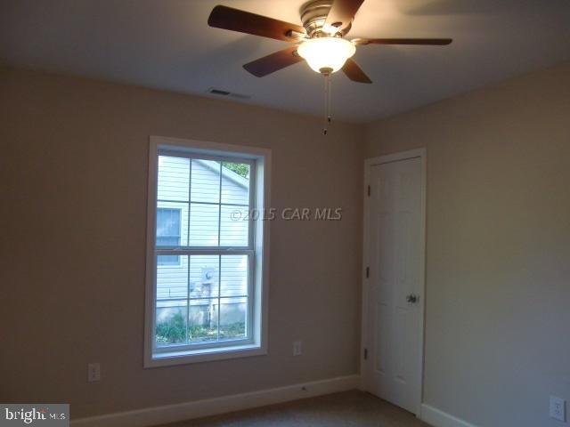 27 Canal Road Ocean Pines, MD 21811 - Photo 18 of 23 an empty room with windows and fan
