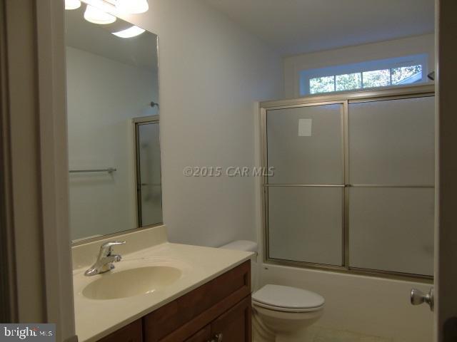 27 Canal Road Ocean Pines, MD 21811 - Photo 20 of 23 a bathroom with a sink a toilet a light fixture and shower