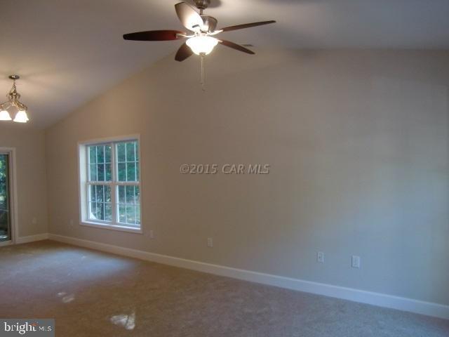 27 Canal Road Ocean Pines, MD 21811 - Photo 6 of 23 an empty room with windows and fan