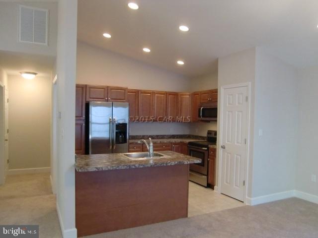 27 Canal Road Ocean Pines, MD 21811 - Photo 10 of 23 a kitchen with stainless steel appliances granite countertop a sink and stove top oven