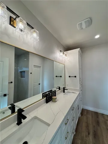 a bathroom with a double vanity sink and mirror