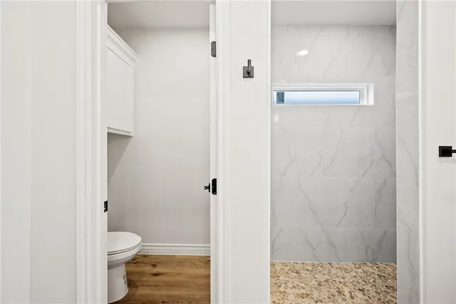 a bathroom with a toilet and a shower