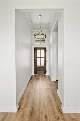 a view of a room with wooden floor exposed radiator and windows