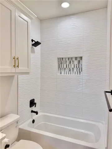 a bathroom with a bathtub a toilet and a shower