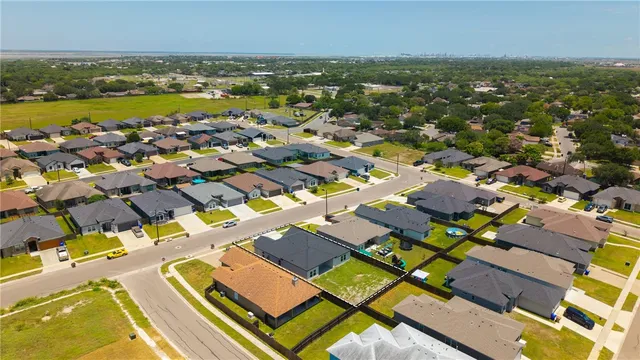 an aerial view of residential houses with outdoor space