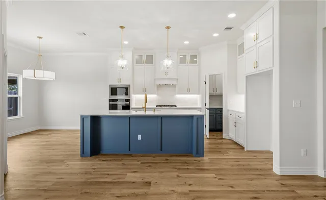 a kitchen with kitchen island cabinets and refrigerator